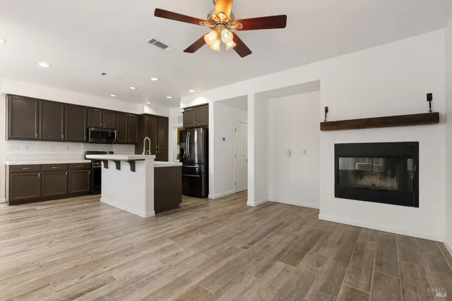 a kitchen with stainless steel appliances granite countertop a stove a sink and a refrigerator