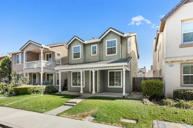 a front view of a residential houses with yard