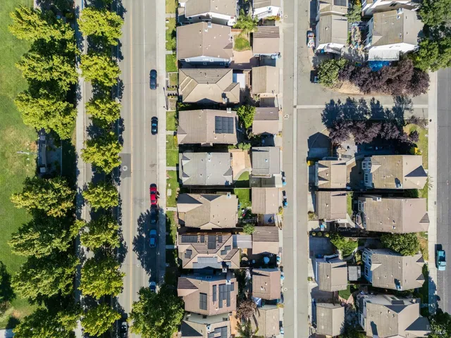 an aerial view of a houses with a yard