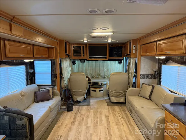 a view of walk in closet with clothes and window