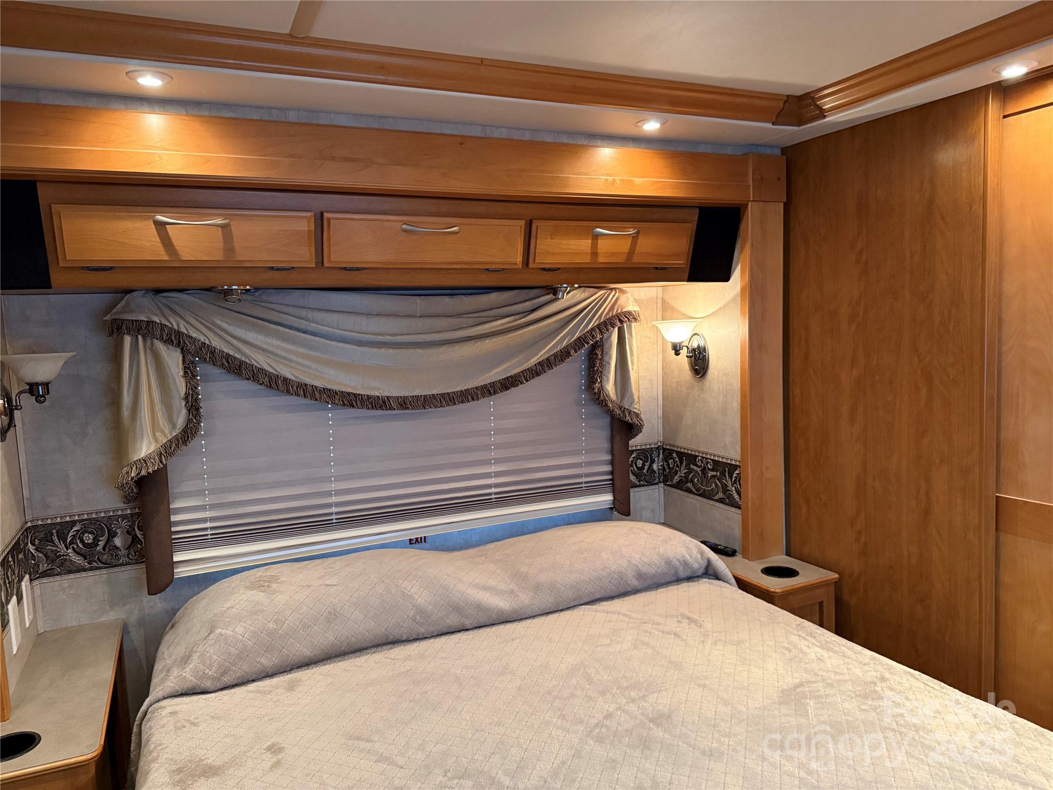 116 Muskhogean Way, Unit D74 Mount Gilead, NC 27306 - Photo 22 of 35 a bedroom with a bed and a chandelier