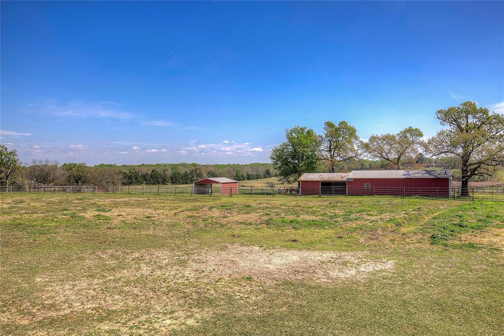 7359 Highway 154 Sulphur Springs, TX 75482 - Photo 37 of 40 Back view of workshop, with two-sided shelter nearby
