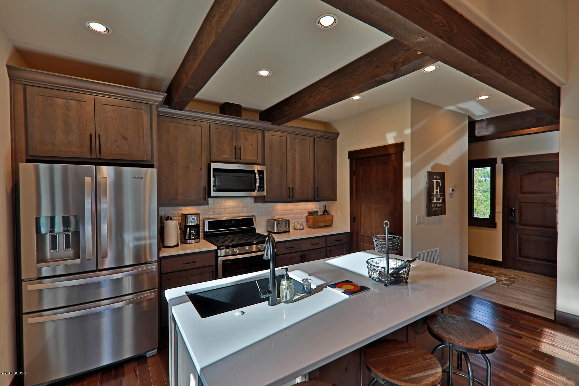 315 Porcupine Ridge Road Fraser, CO 80442 - Photo 4 of 15 a kitchen with refrigerator cabinets and wooden floor