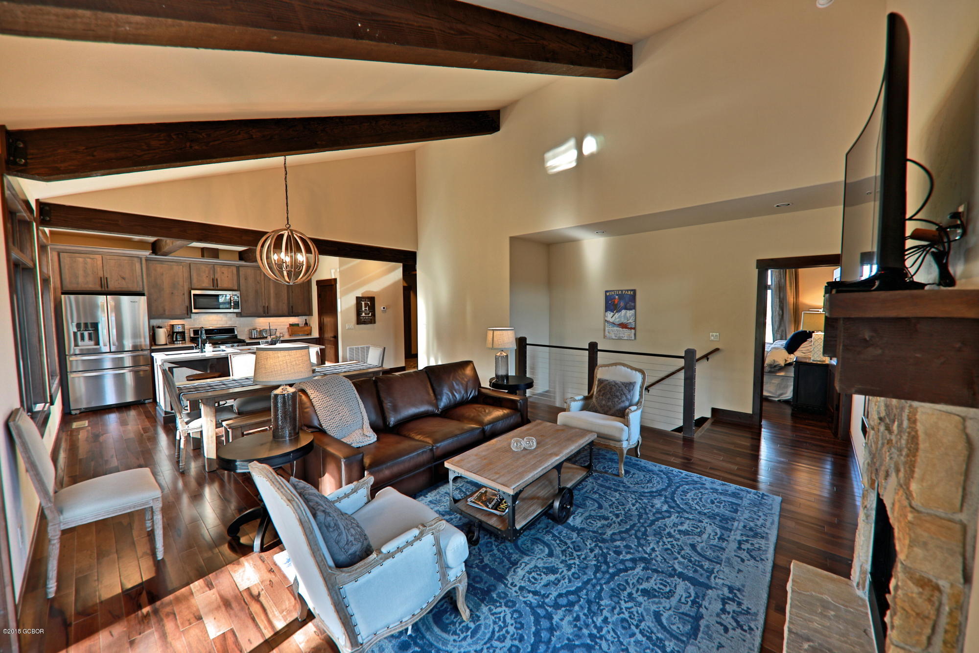 315 Porcupine Ridge Road Fraser, CO 80442 - Photo 6 of 15 a living room with furniture a fireplace and a flat screen tv