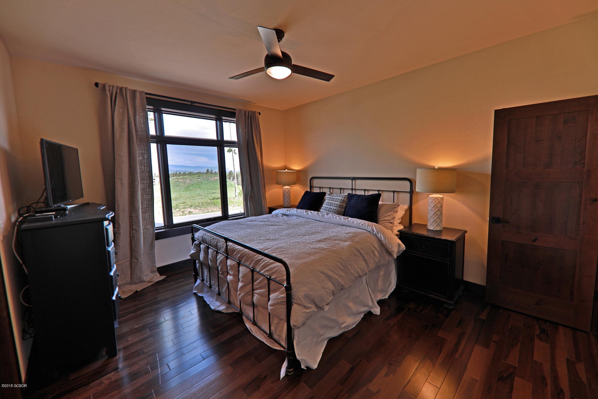 315 Porcupine Ridge Road Fraser, CO 80442 - Photo 9 of 15 a bedroom with a bed and wooden floor