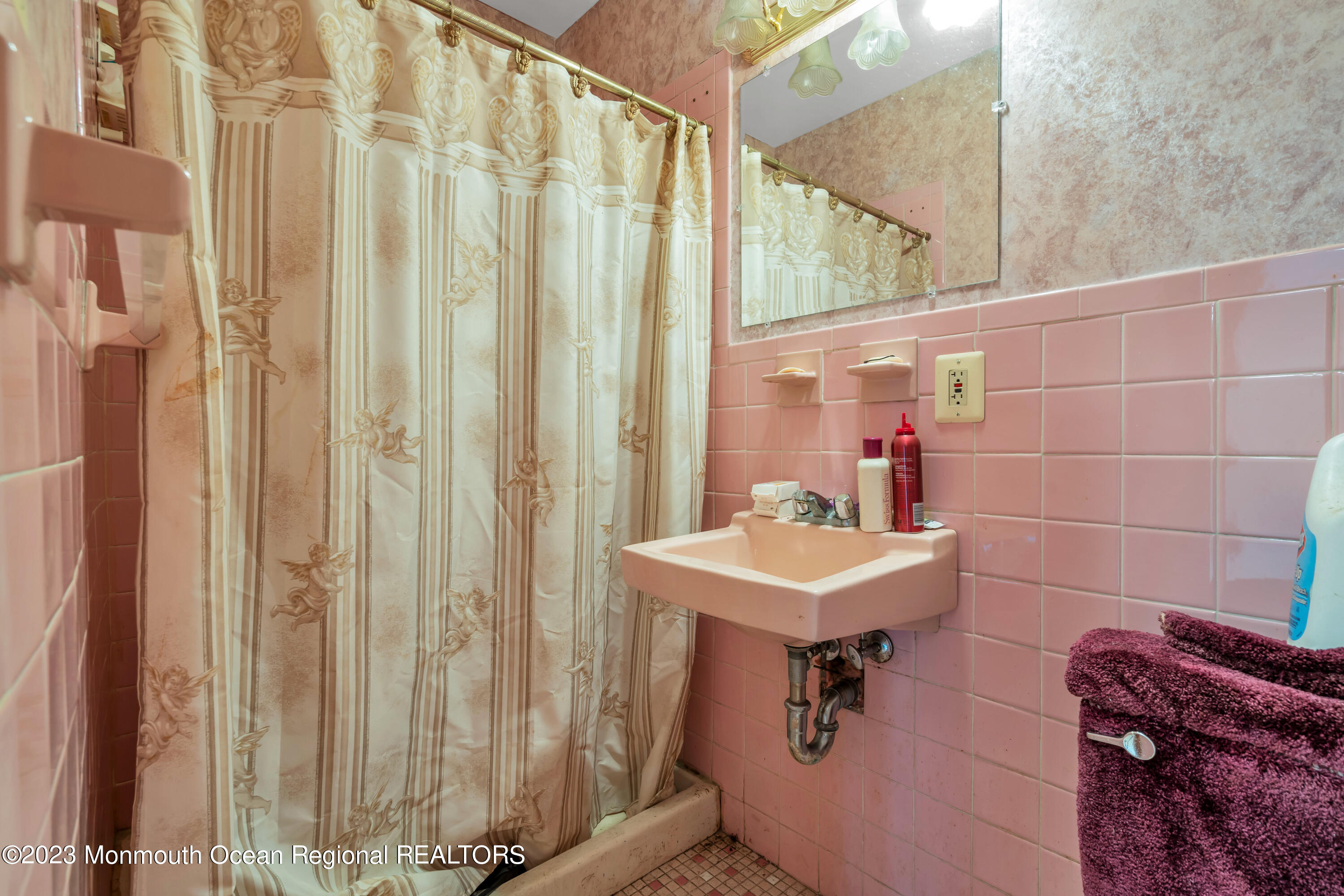 74 Willow Drive Jackson, NJ 08527 - Photo 15 of 20 a bathroom with a sink a mirror and a shower curtain