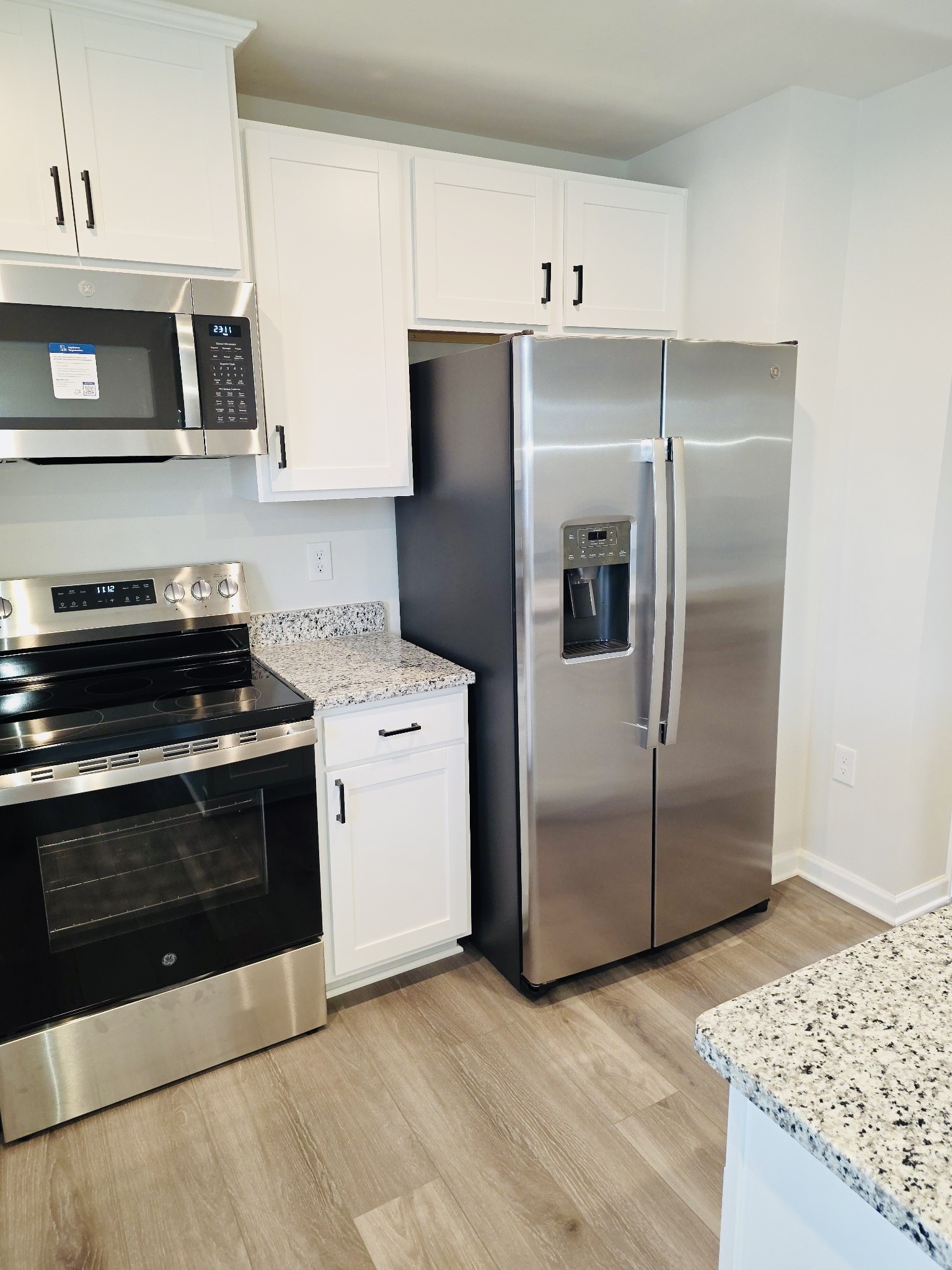 2112 Wisteria Loop Franklin, KY 42134 - Photo 5 of 14 a kitchen with stainless steel appliances granite countertop a refrigerator a stove a microwave and cabinets