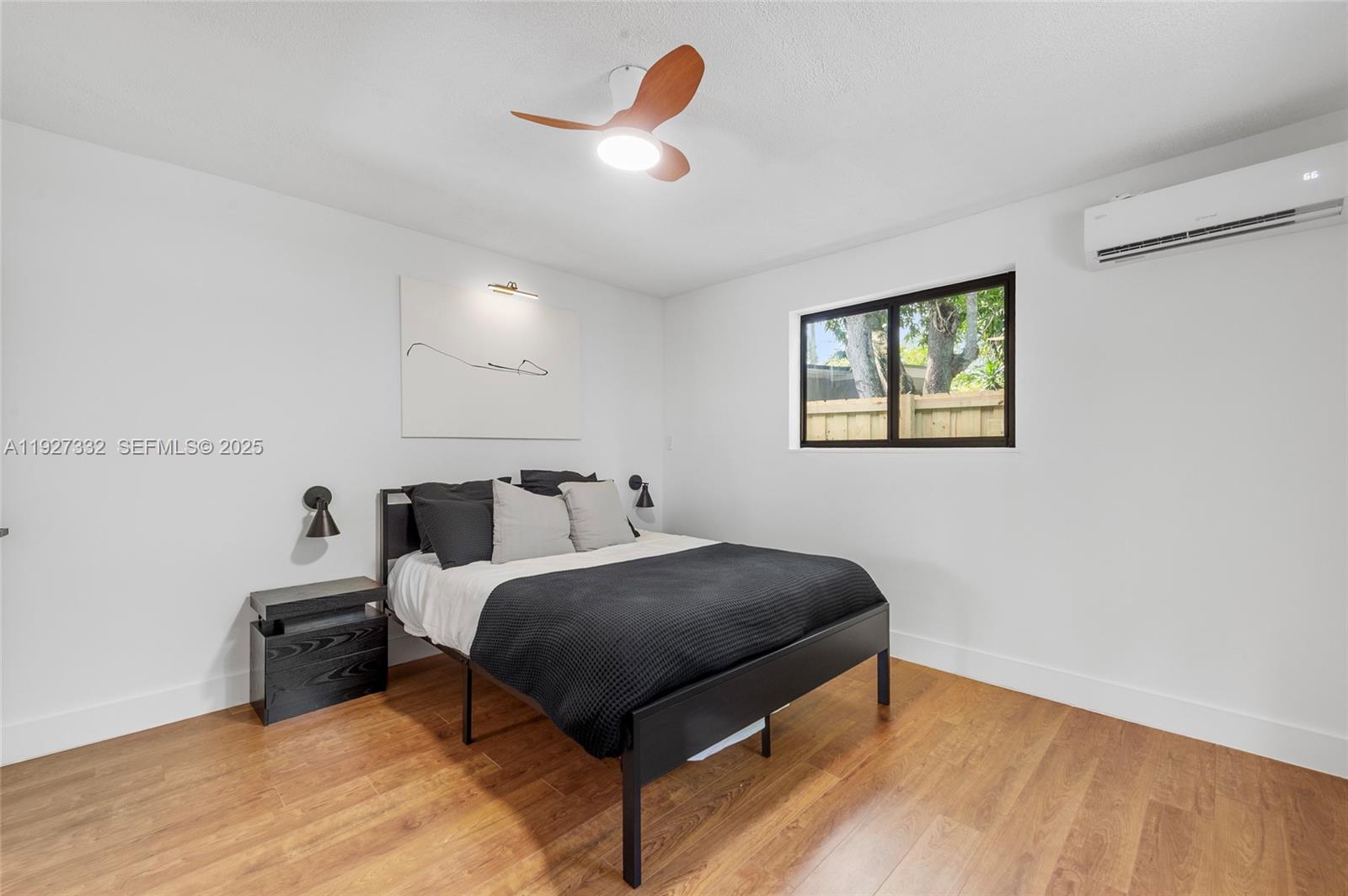 485 Northwest 132nd Street North Miami, FL 33168 - Photo 12 of 15 a bedroom with a bed and a chandelier