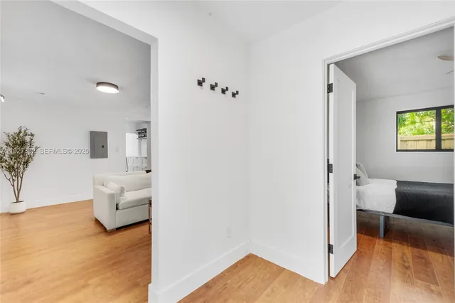 a view of a bedroom with furniture and wooden floor