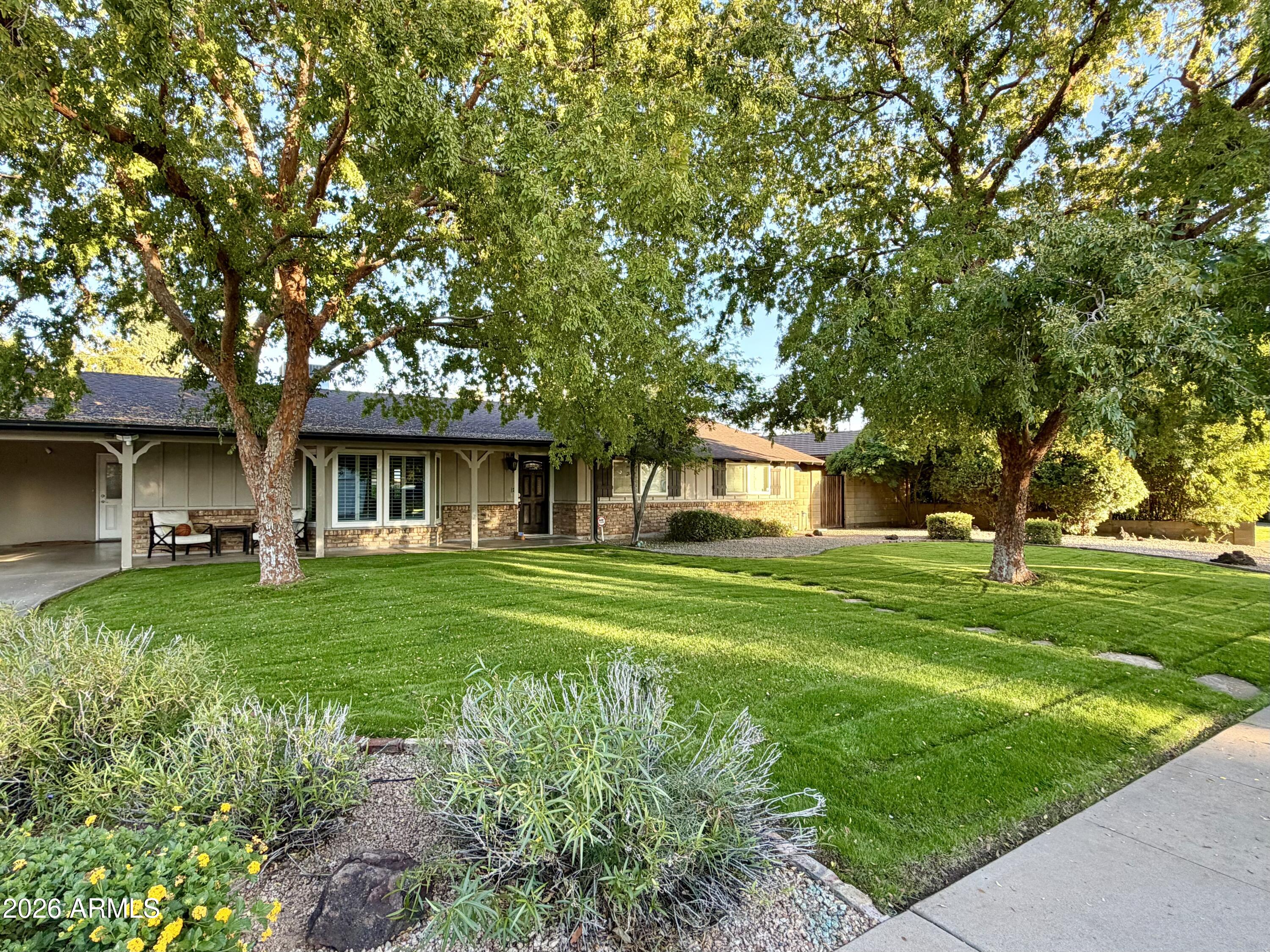7113 North 8th Avenue Phoenix, AZ 85021 - Photo 1 of 57 a front view of a house with a garden