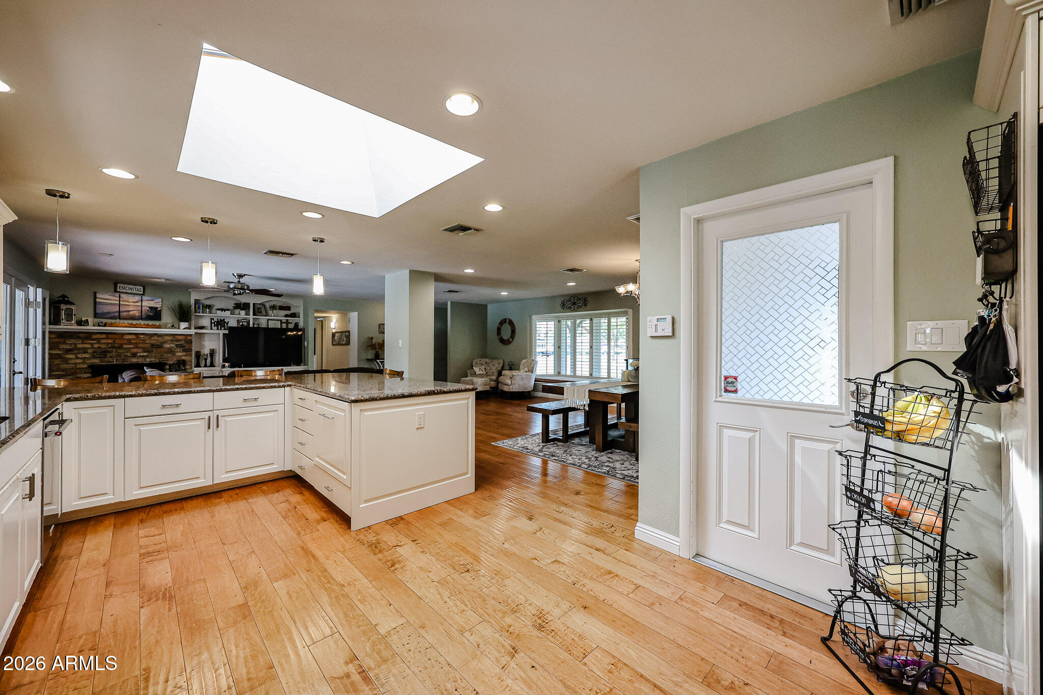 7113 North 8th Avenue Phoenix, AZ 85021 - Photo 22 of 57 a large white kitchen with wooden floor and a refrigerator