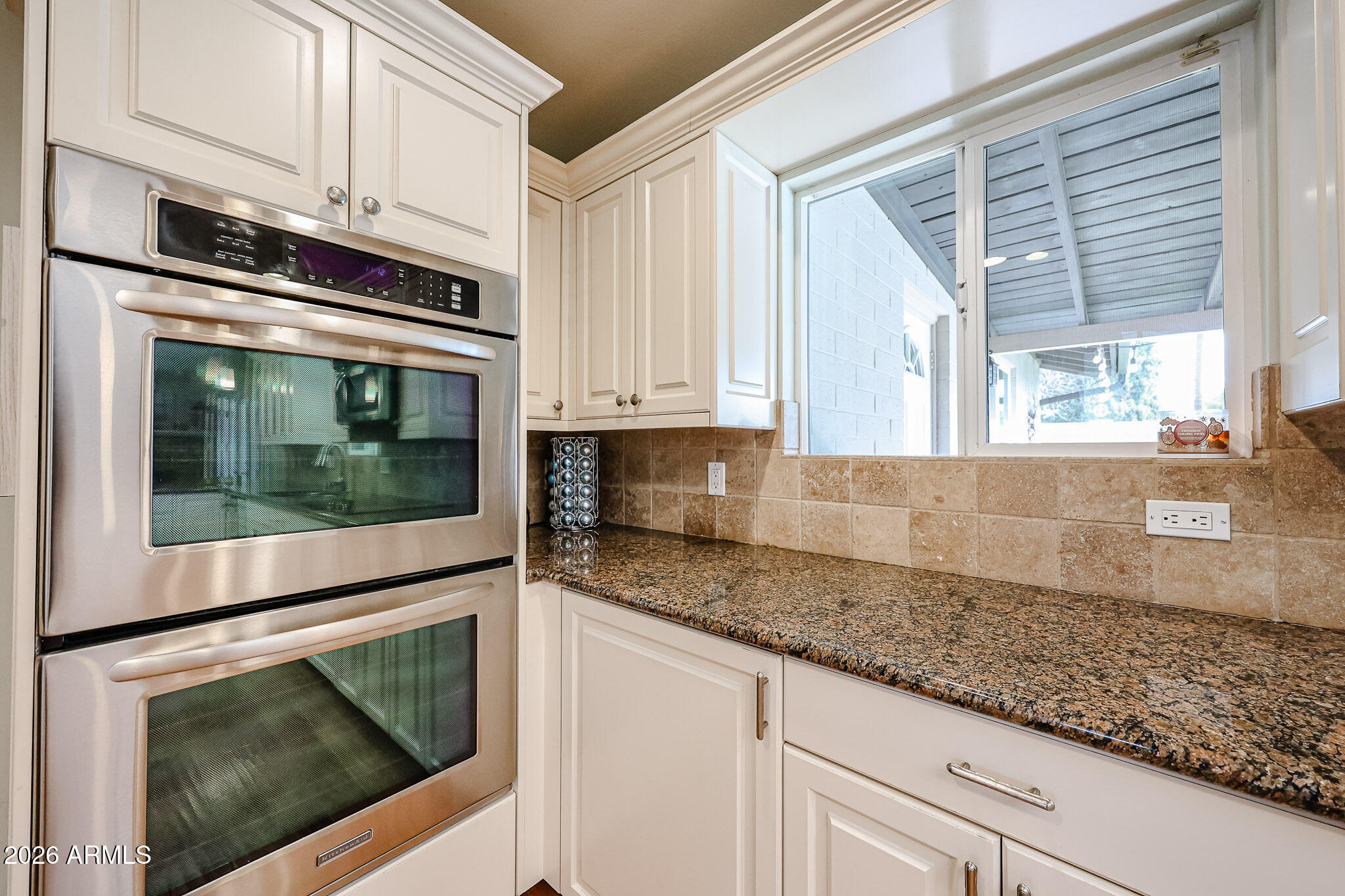 7113 North 8th Avenue Phoenix, AZ 85021 - Photo 26 of 57 a kitchen with granite countertop white cabinets stainless steel appliances and a counter space