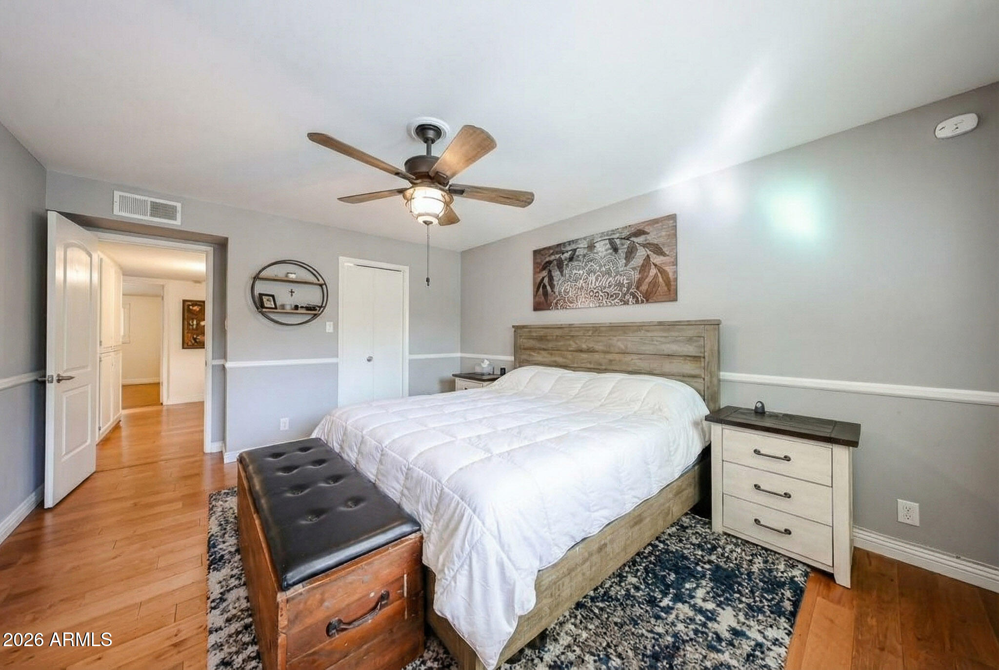 7113 North 8th Avenue Phoenix, AZ 85021 - Photo 29 of 57 a bedroom with a bed and wooden floor