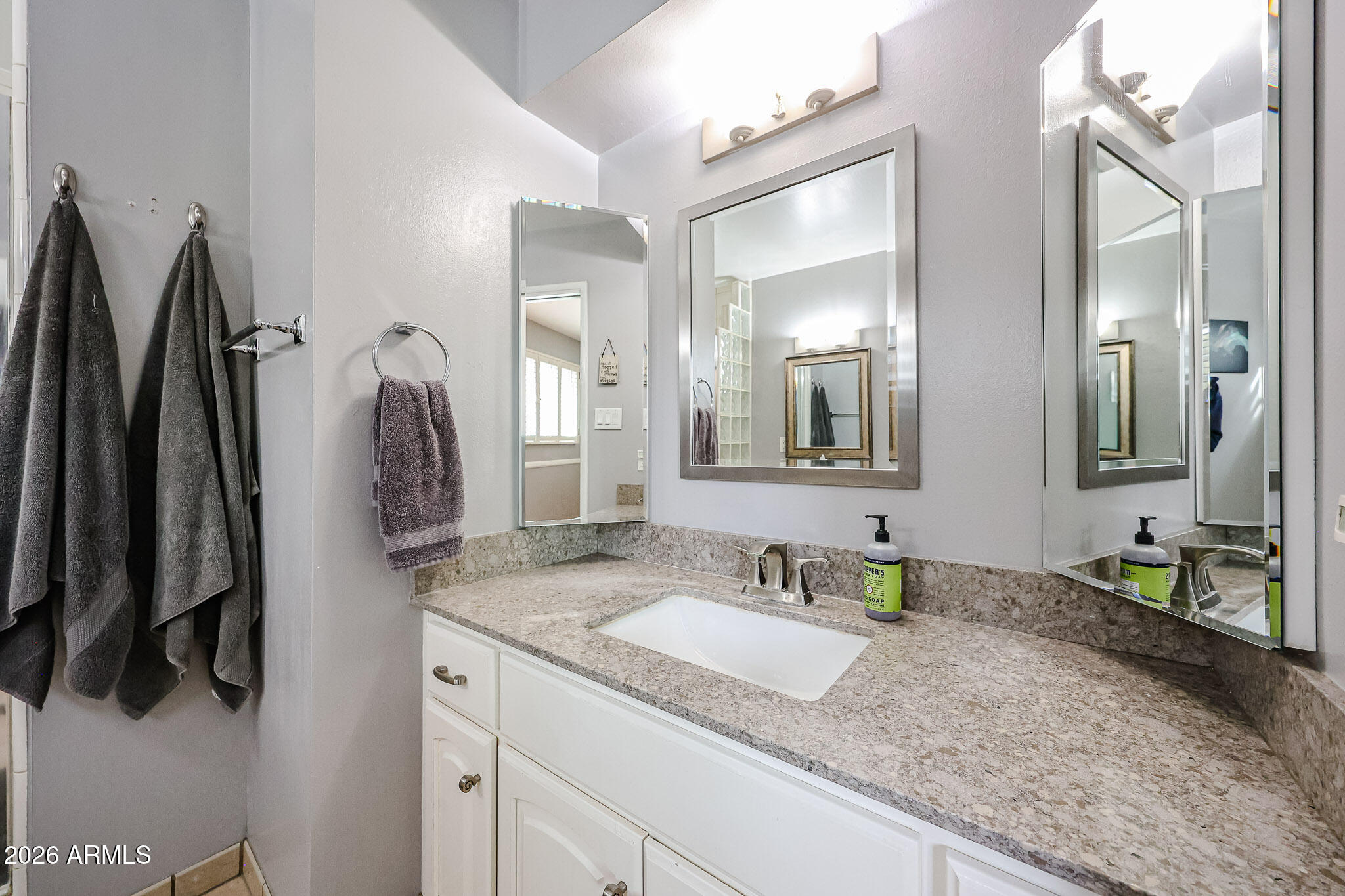 7113 North 8th Avenue Phoenix, AZ 85021 - Photo 33 of 57 a bathroom with a granite countertop sink and a mirror