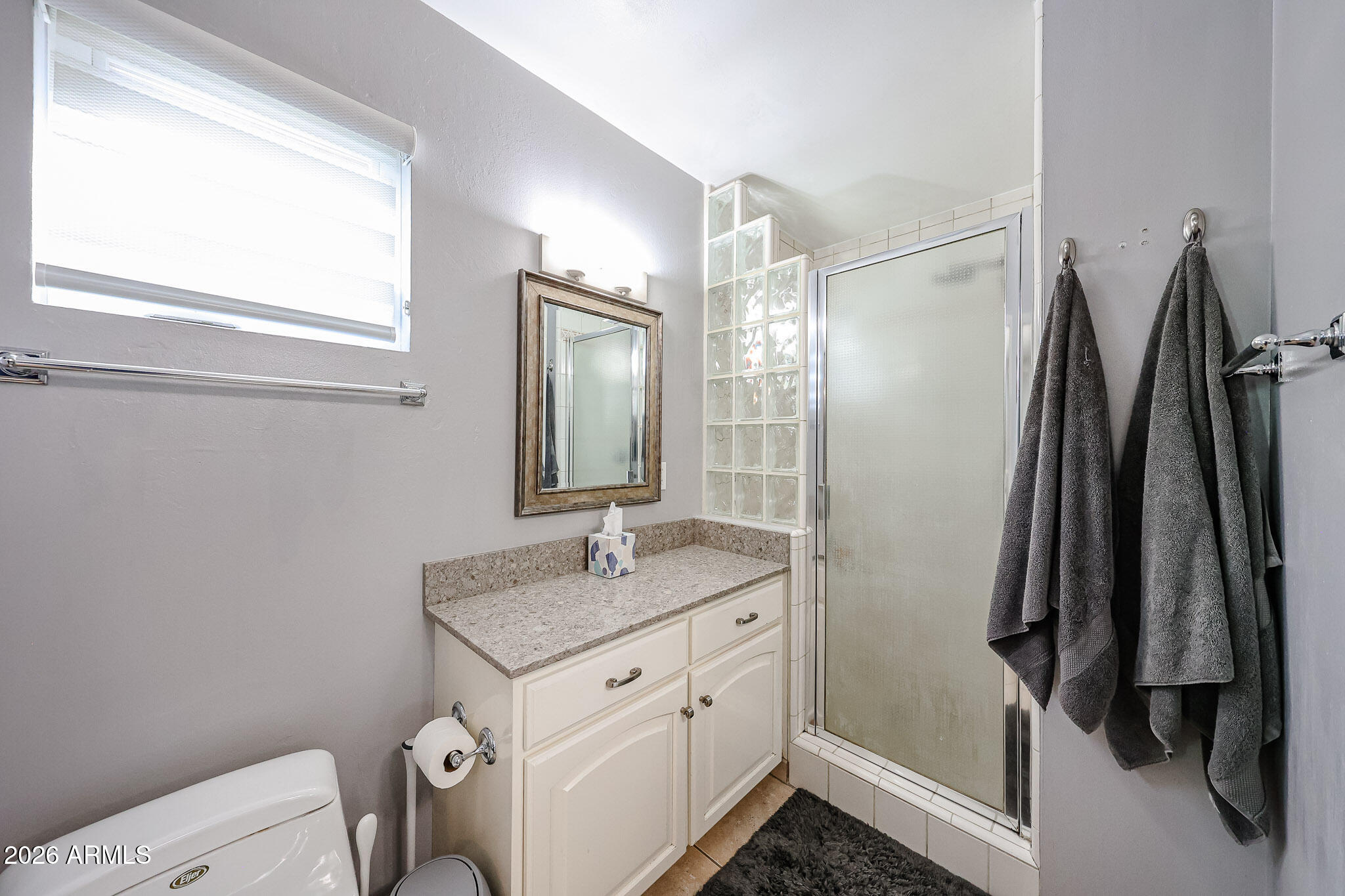 7113 North 8th Avenue Phoenix, AZ 85021 - Photo 34 of 57 a bathroom with a granite countertop sink toilet and a mirror