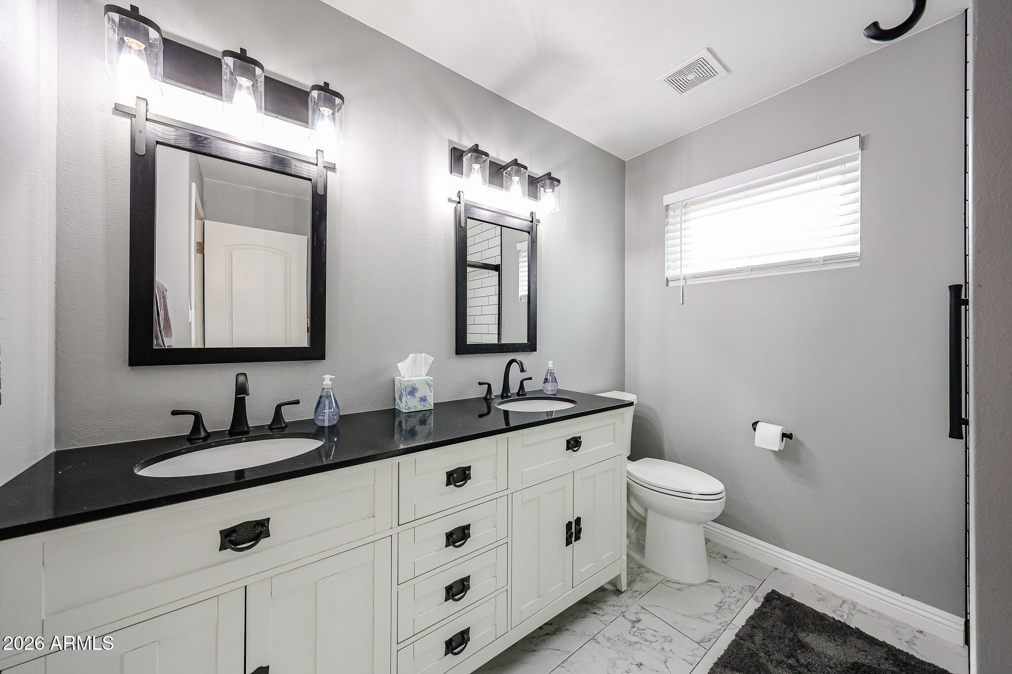 7113 North 8th Avenue Phoenix, AZ 85021 - Photo 37 of 57 a bathroom with double vanity and a mirror