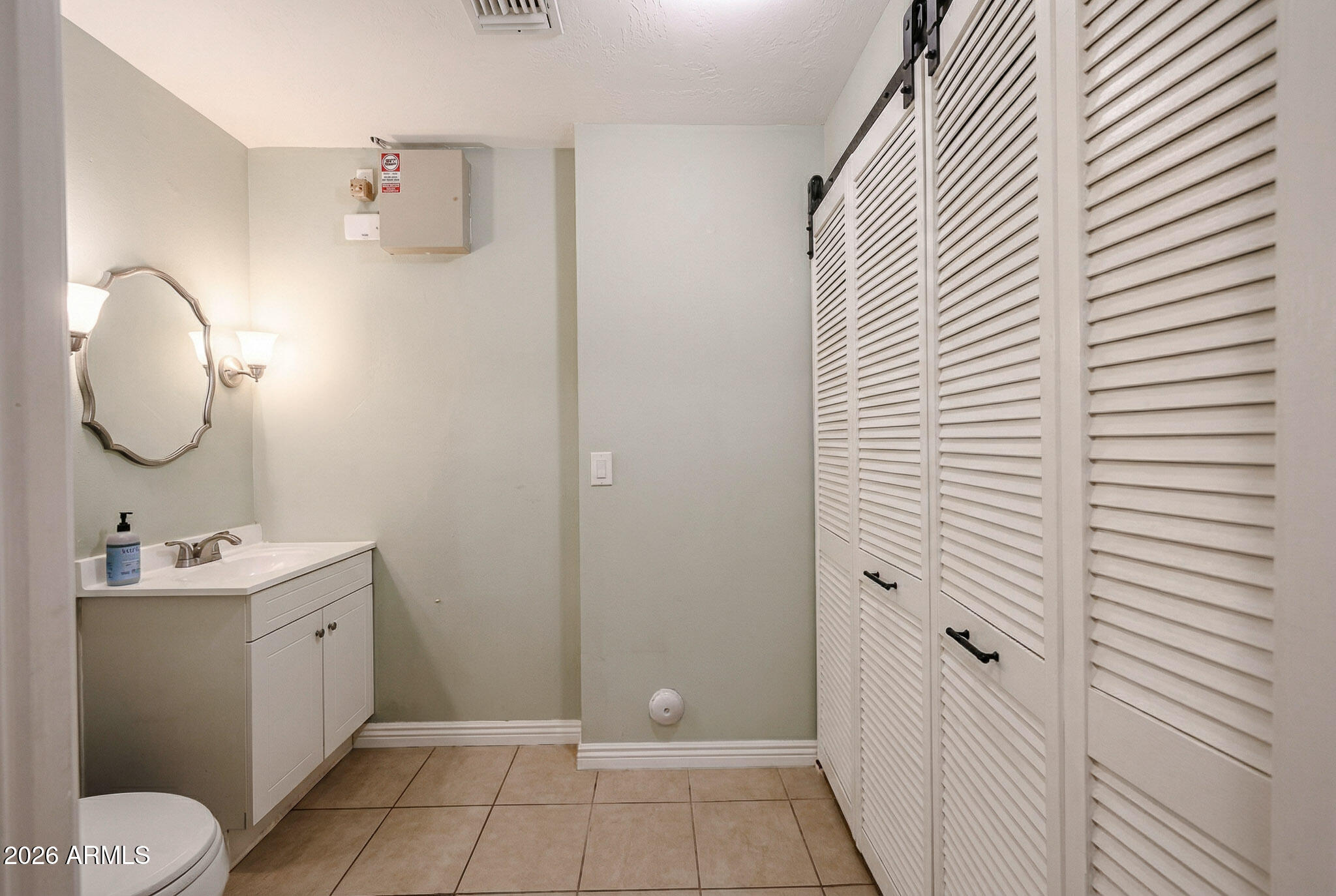7113 North 8th Avenue Phoenix, AZ 85021 - Photo 44 of 57 a bathroom with a toilet sink and mirror
