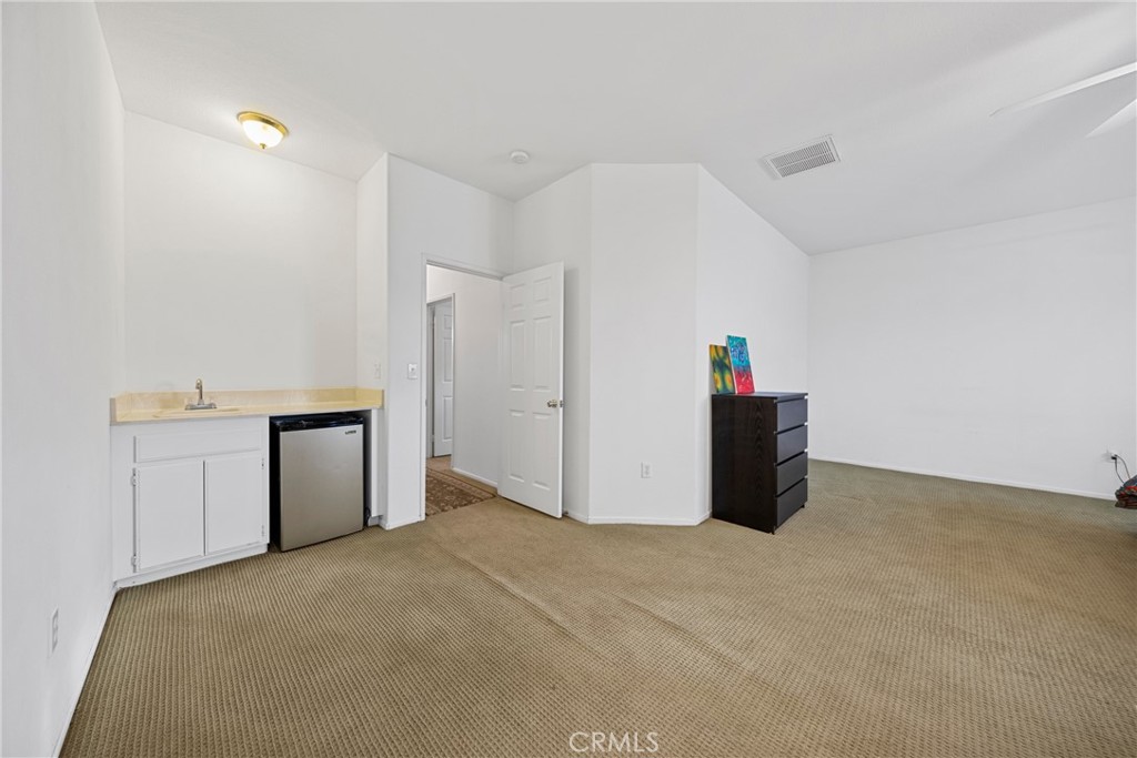 1727 Miranda Lane Beaumont, CA 92223 - Photo 17 of 47 a view of a kitchen with refrigerator and white cabinets
