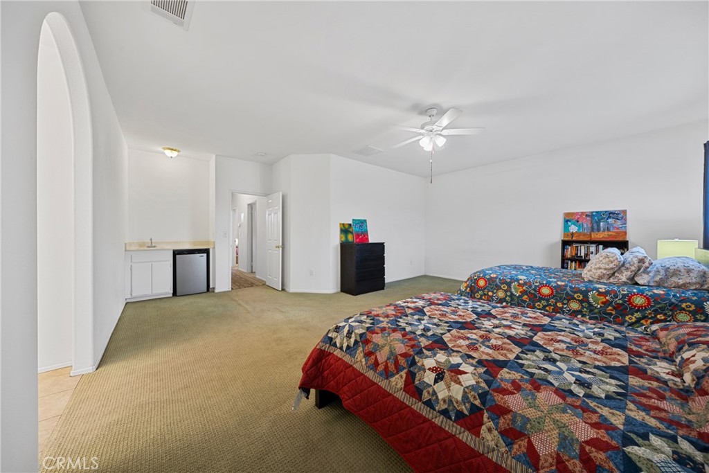 1727 Miranda Lane Beaumont, CA 92223 - Photo 19 of 47 a bedroom with a bed and a chandelier