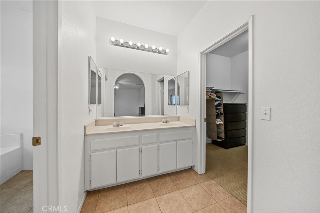 1727 Miranda Lane Beaumont, CA 92223 - Photo 20 of 47 a spacious bathroom with a double vanity sink and a mirror