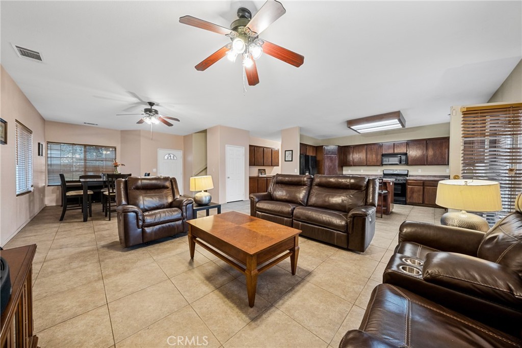 1727 Miranda Lane Beaumont, CA 92223 - Photo 2 of 47 a living room with furniture kitchen view and a chandelier