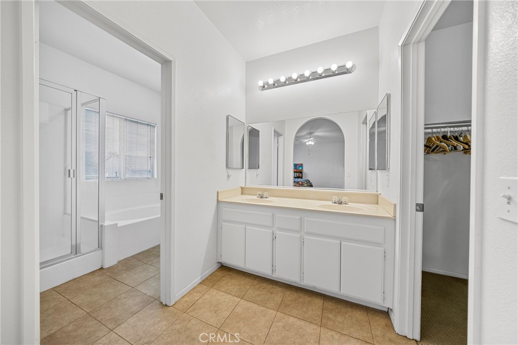 1727 Miranda Lane Beaumont, CA 92223 - Photo 22 of 47 a bathroom with a double vanity sink mirror and shower