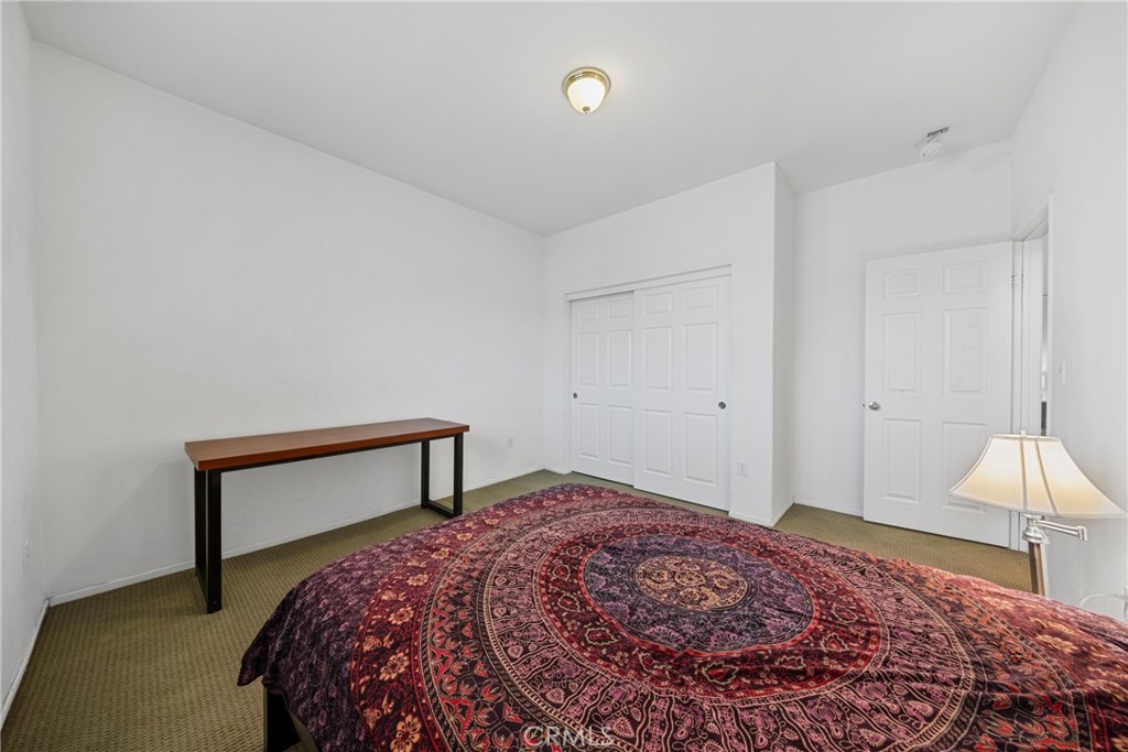 1727 Miranda Lane Beaumont, CA 92223 - Photo 29 of 47 a bedroom with a bed and a dresser