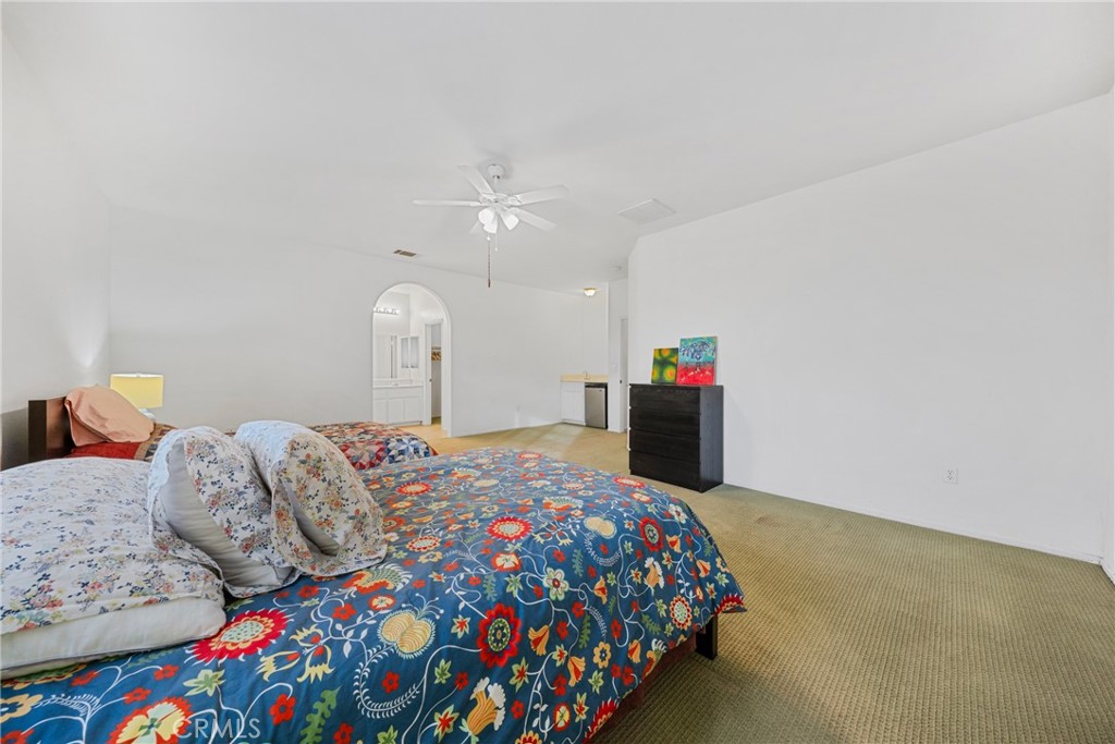 1727 Miranda Lane Beaumont, CA 92223 - Photo 35 of 47 a bedroom with a bed and a chandelier