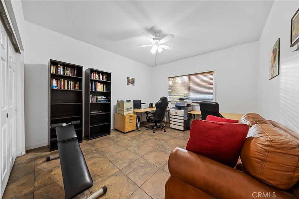1727 Miranda Lane Beaumont, CA 92223 - Photo 36 of 47 a living room with furniture a ceiling fan and a window