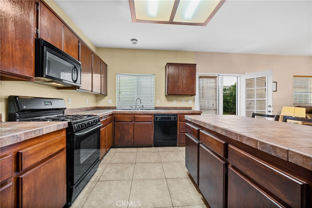 1727 Miranda Lane Beaumont, CA 92223 - Photo 6 of 47 a large kitchen with stainless steel appliances granite countertop a stove and a sink