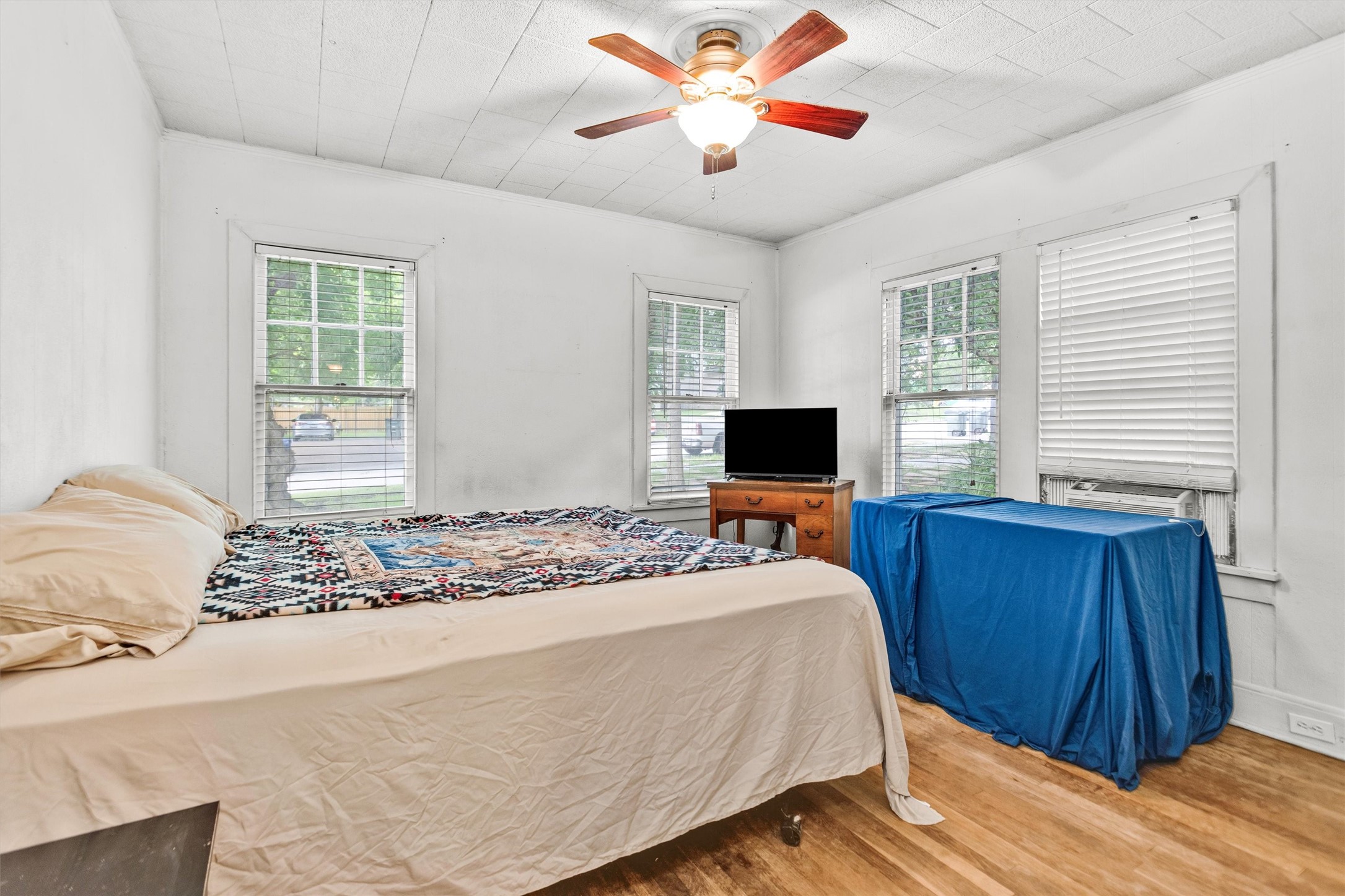 1720 18th Street Huntsville, TX 77340 - Photo 25 of 37 a bedroom with a bed and a flat screen tv