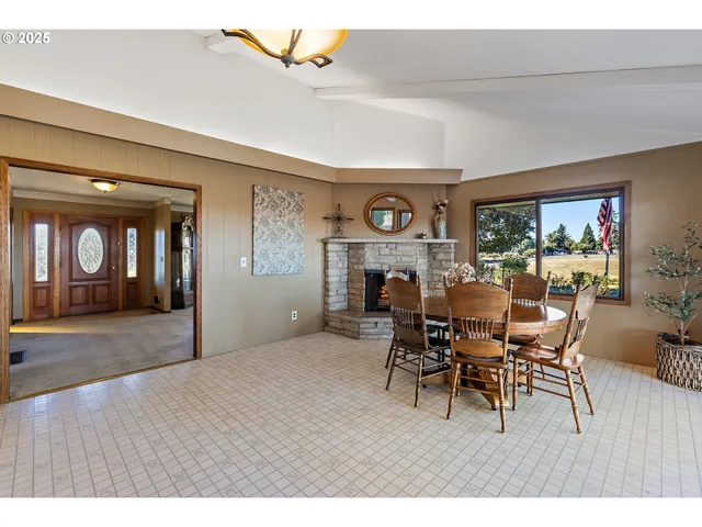 a dining room with furniture and window