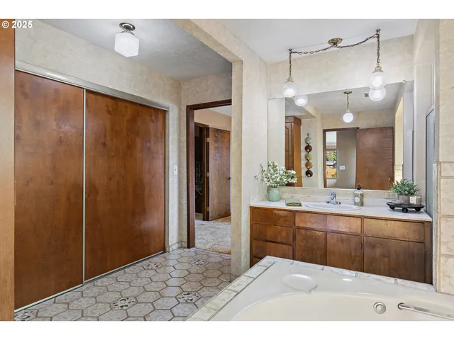 a bathroom with a sink a large mirror and a shower