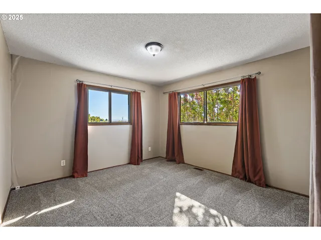 an empty room with windows and closet