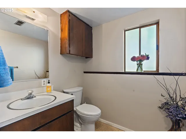 a bathroom with a sink toilet and mirror