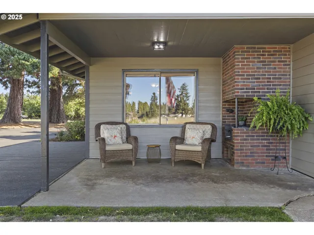 a dining room with furniture and a floor to ceiling window