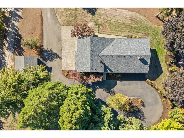 an aerial view of a house with yard swimming pool and outdoor seating
