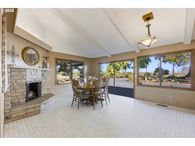 a dining room with furniture wooden floor clock and a chandelier