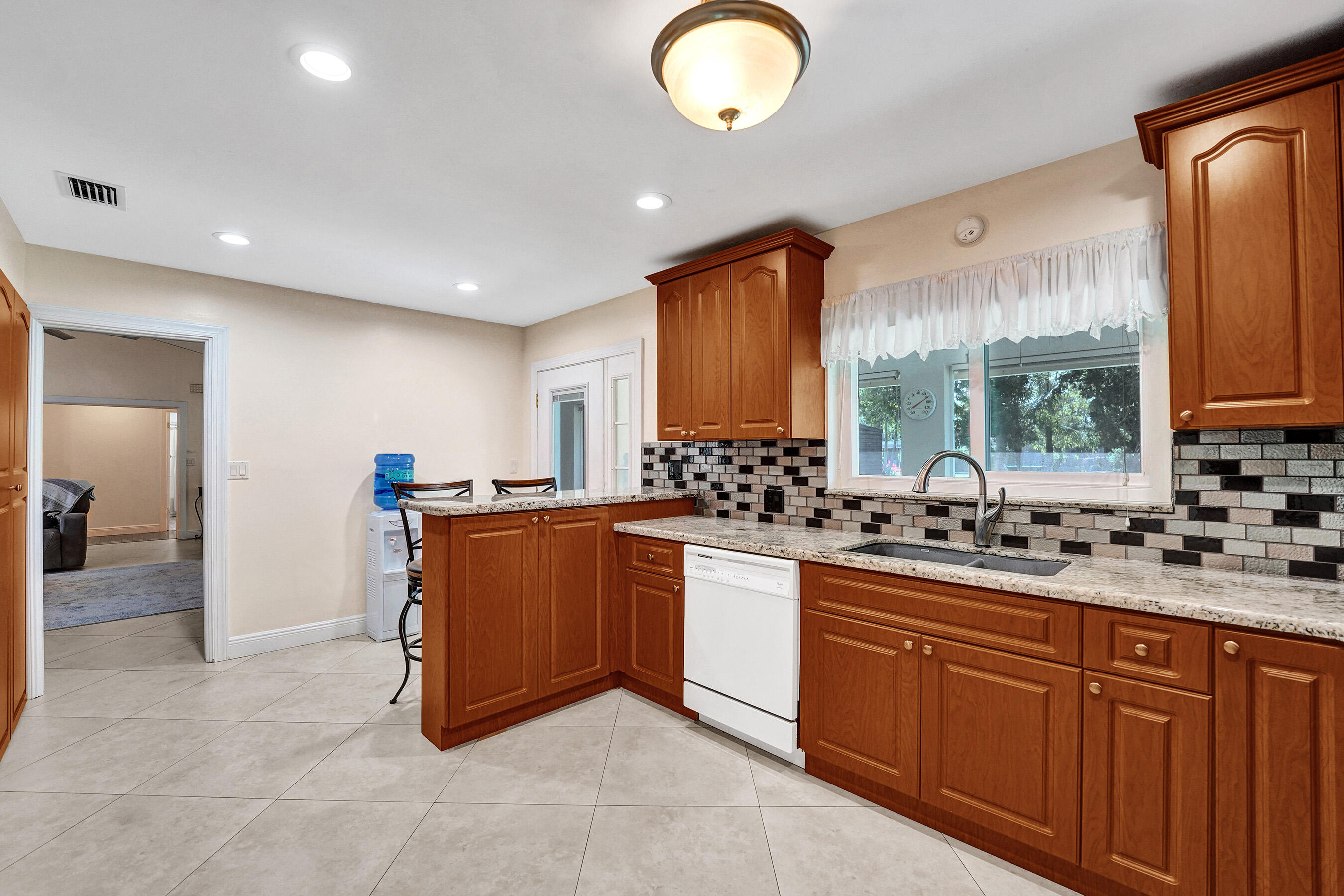 5181 Southwest 89th Terrace Cooper City, FL 33328 - Photo 15 of 56 a large kitchen with stainless steel appliances granite countertop a sink and cabinets