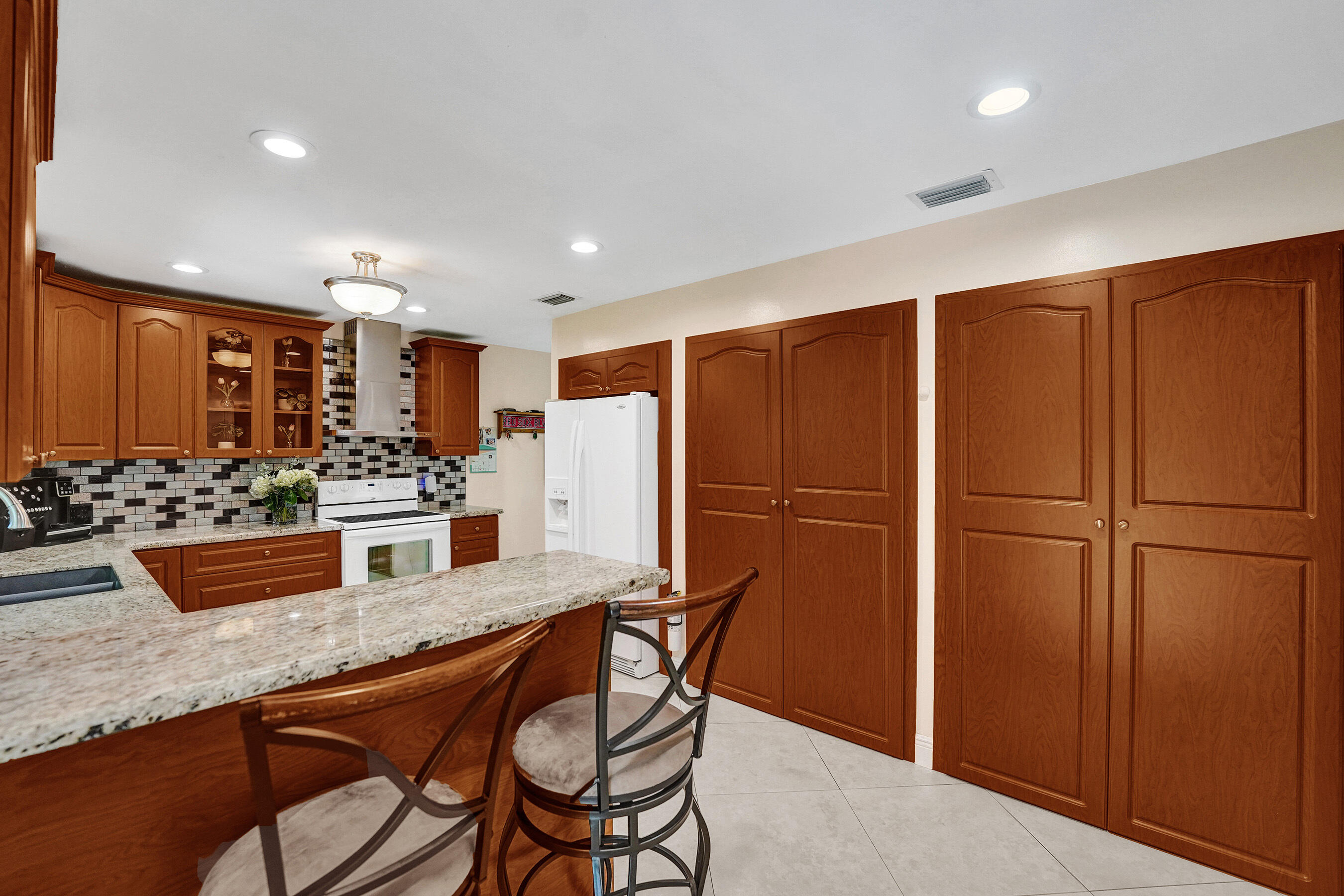 5181 Southwest 89th Terrace Cooper City, FL 33328 - Photo 18 of 56 a kitchen with stainless steel appliances granite countertop a refrigerator and a counter top space