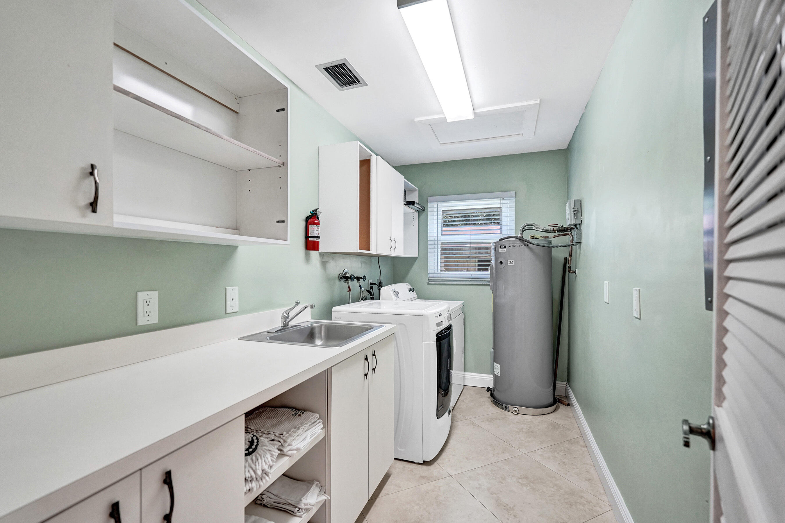5181 Southwest 89th Terrace Cooper City, FL 33328 - Photo 31 of 56 a room with a sink cabinets and refrigerator