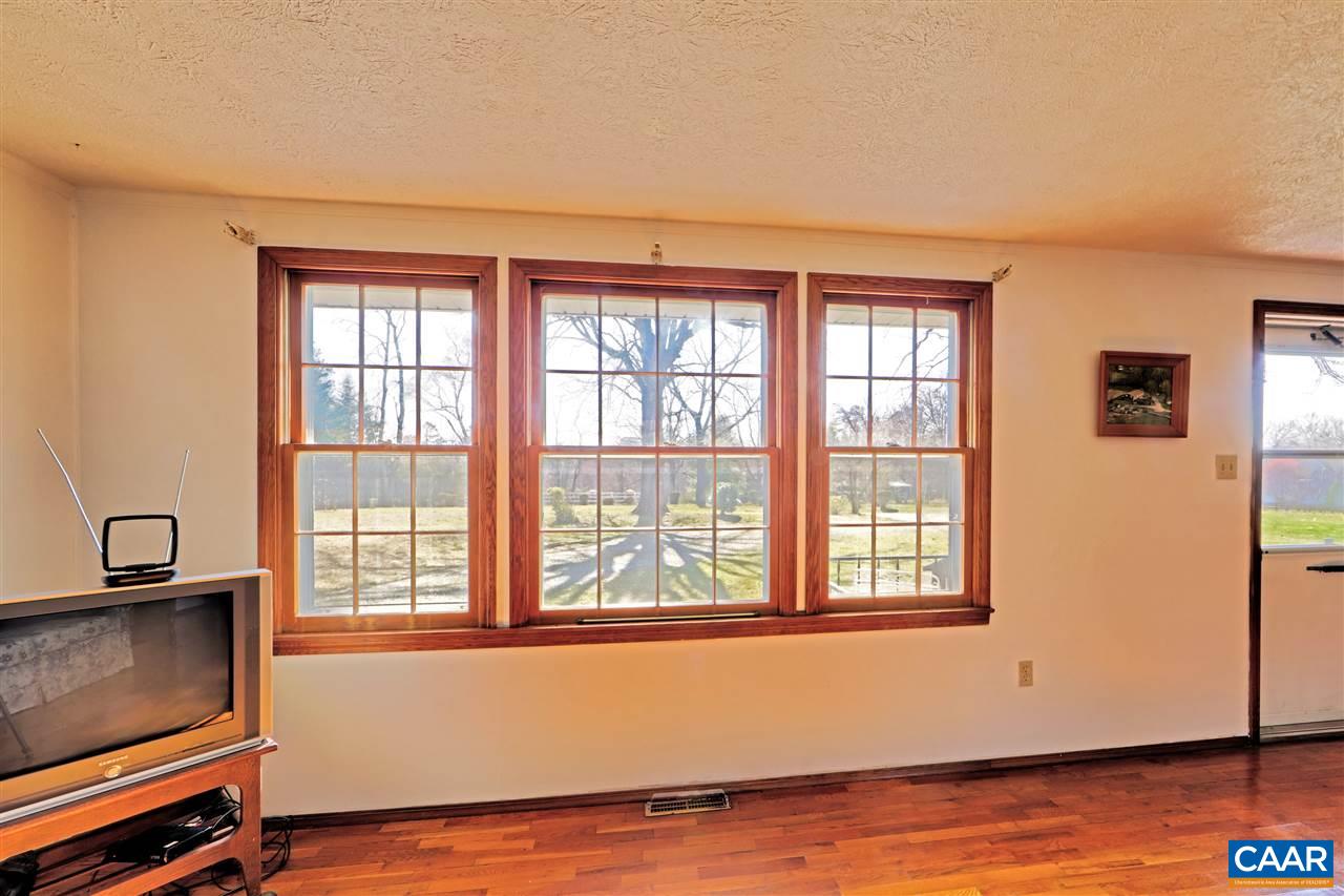 869 Black Cat Road Keswick, VA 22947 - Photo 11 of 20 a view of an empty room with wooden floor and a window