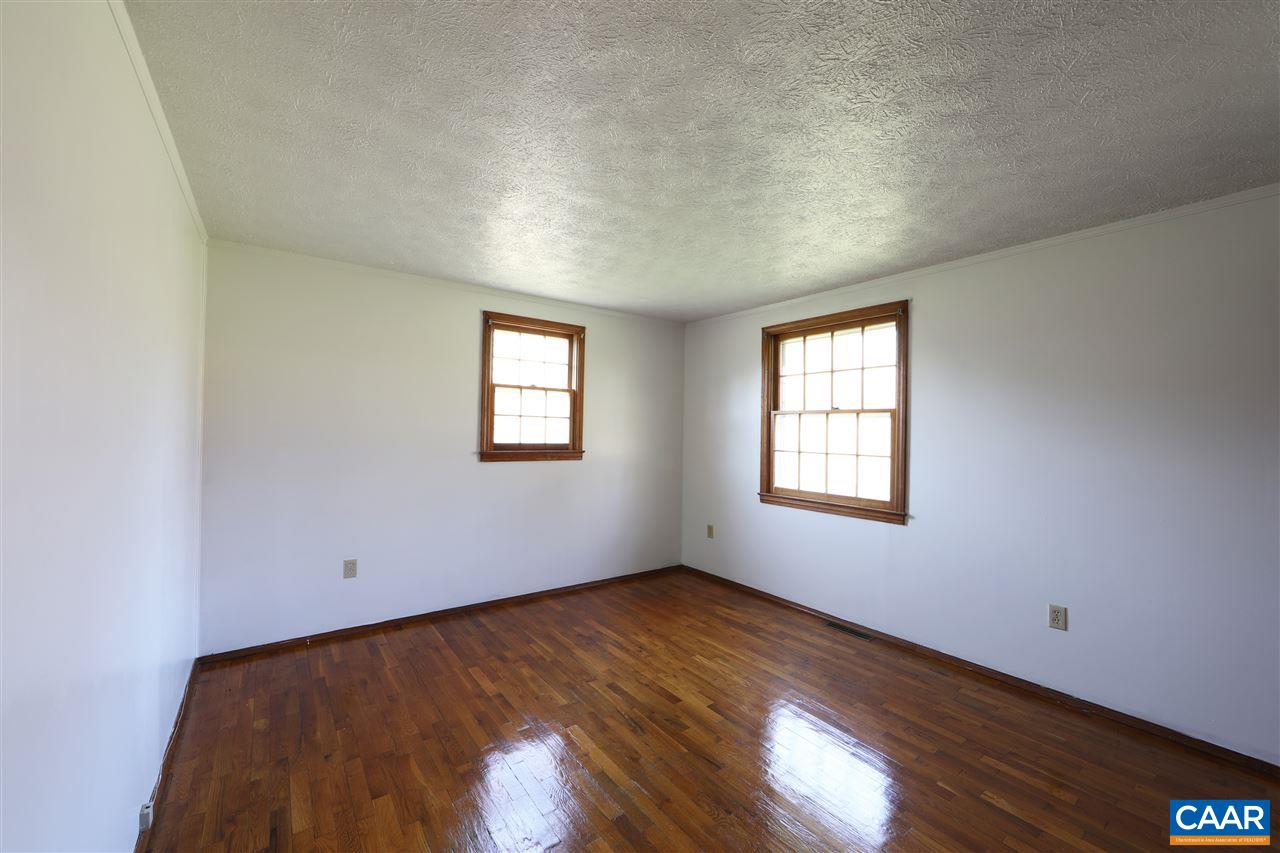 869 Black Cat Road Keswick, VA 22947 - Photo 12 of 20 an empty room with wooden floor and windows
