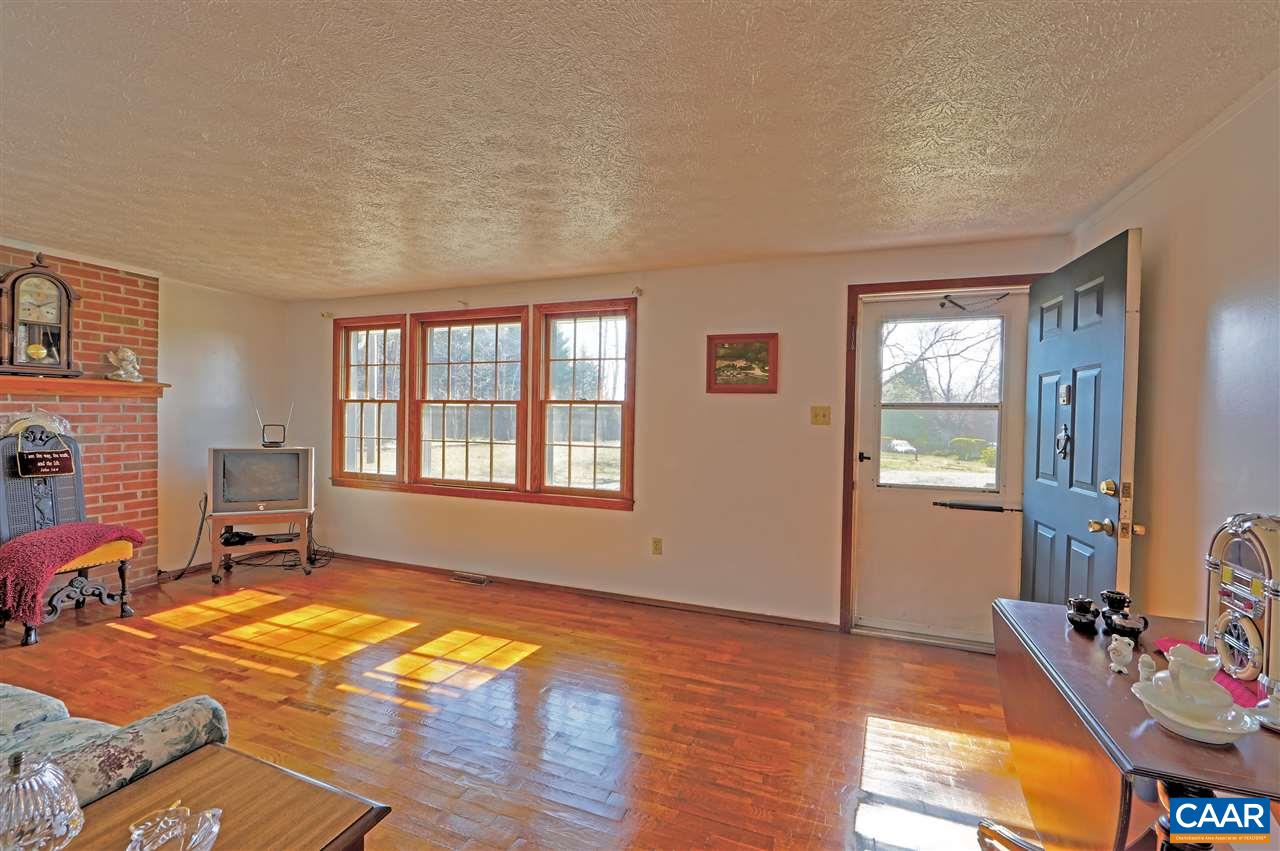869 Black Cat Road Keswick, VA 22947 - Photo 4 of 20 a view of a livingroom with lounge chair and a window