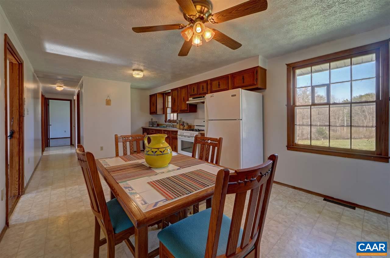869 Black Cat Road Keswick, VA 22947 - Photo 5 of 20 a view of a dining room with furniture and a chandelier