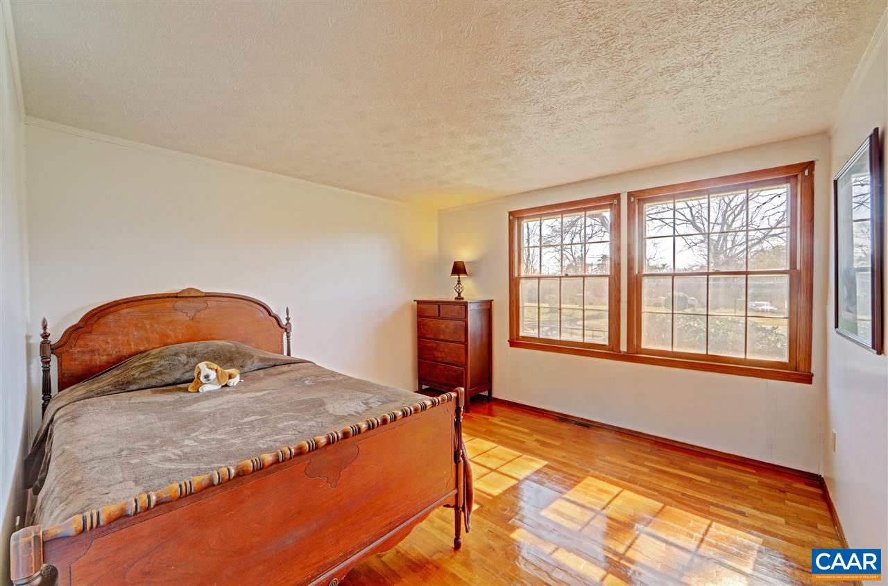 869 Black Cat Road Keswick, VA 22947 - Photo 7 of 20 a bedroom with a bed and a window