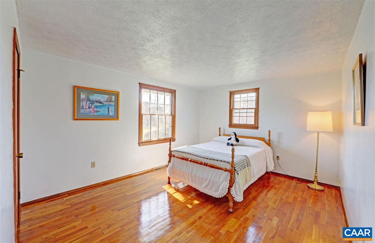 869 Black Cat Road Keswick, VA 22947 - Photo 8 of 20 a bedroom with a bed and window