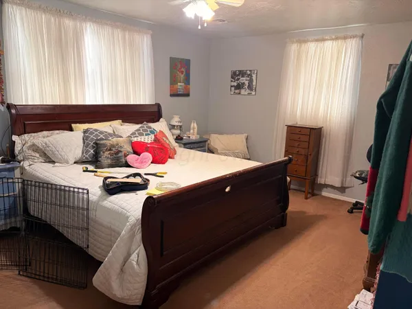 a bed sitting in a bedroom next to a window