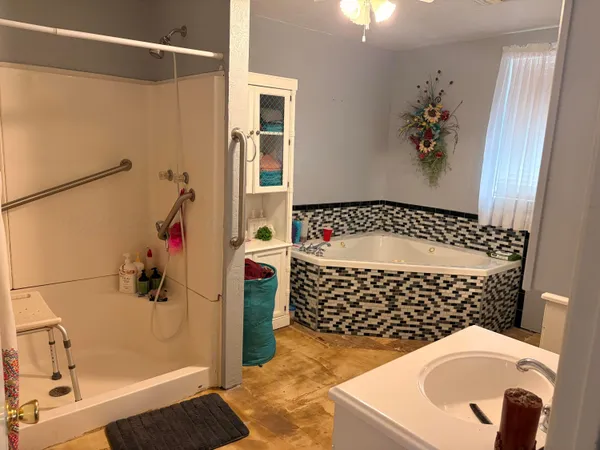 a bathroom with a sink toilet and shower