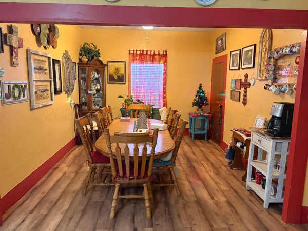 a view of a dining room with furniture and wooden floor